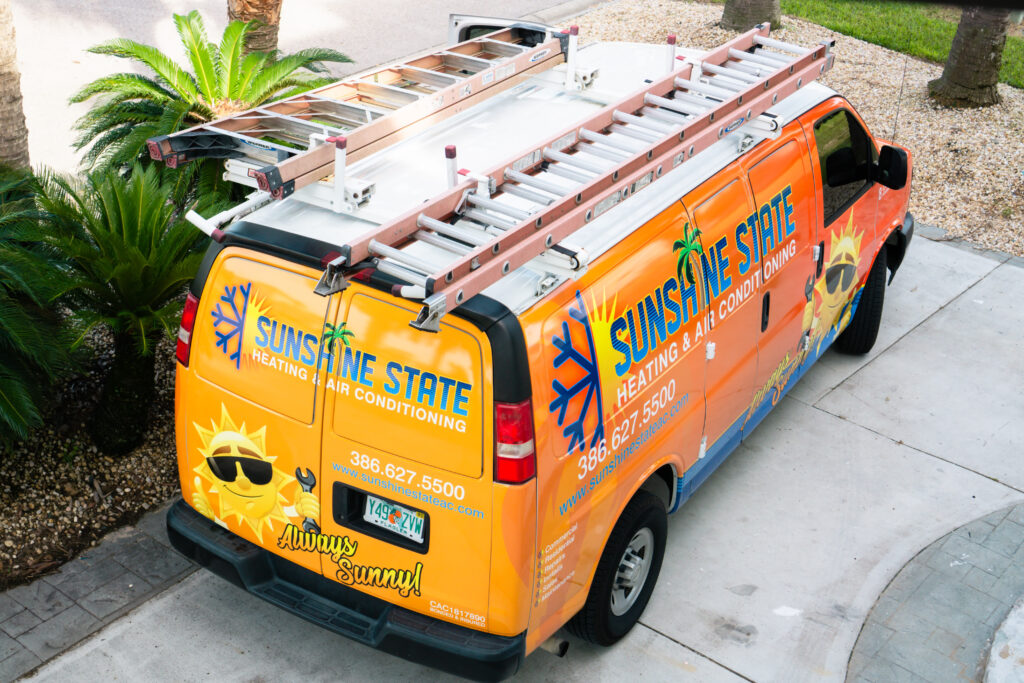 Sunshine State Heating and Air Conditioning's orange branded service van with ladder rack